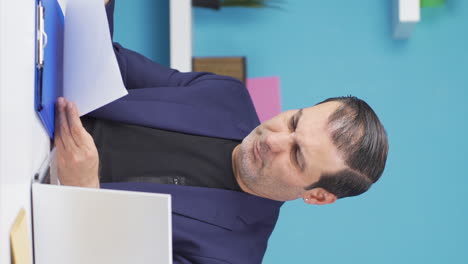 Vertical-video-of-Businessman-upset-with-negative-paperwork-results.
